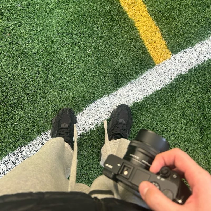 Sebas holding his camera on the soccer field